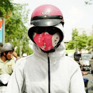 Teen-ager with a pink mask and gray sweater 