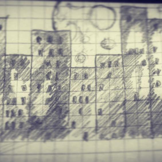 A moon behind skyscrapers