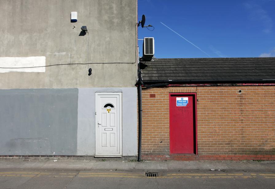 Pentagon and other shapes amid Closed doors and infinite sky.