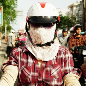 Girl with a casual and flowery "Cover-up Style" driving on the streets of H.C.M.C. Girl with a casual and flowery