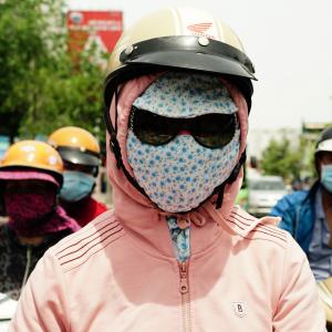 Teen-ager with a pink sweater and flowery mask 